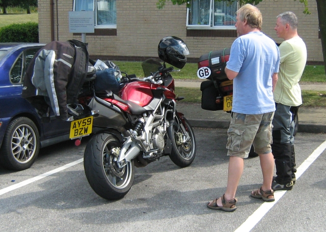IW and SL looking at SL's Aprilia Shiver in a plain car park at blyth services